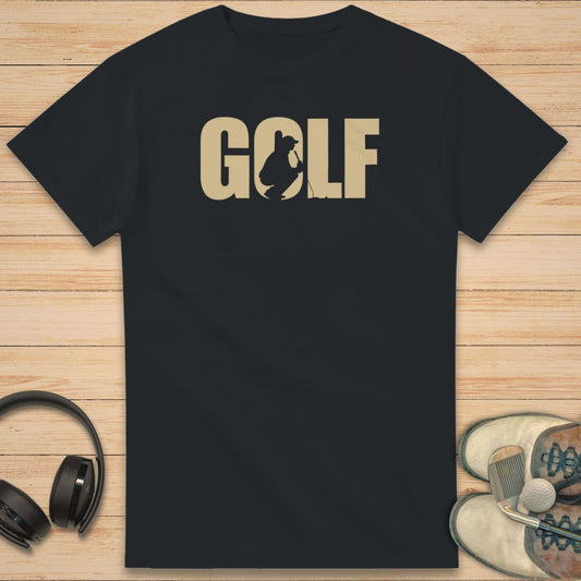 Golf C T-Shirt in Black on a light wooden floor lying next to headphones and golf shoes.