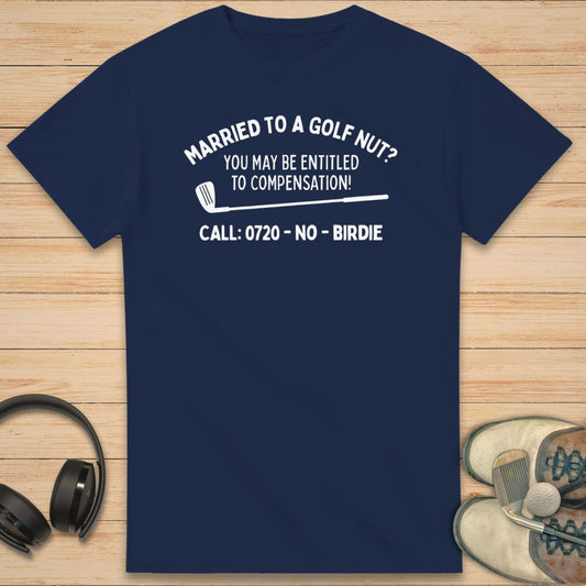 Golf Nut T-Shirt in Navy on a light wooden floor lying next to headphones and golf shoes.