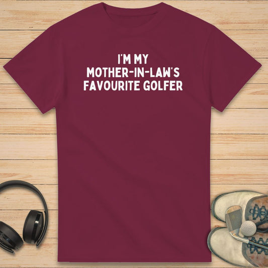 Mother-In-Law T-Shirt in Maroon on a light wooden floor lying next to headphones and golf shoes.