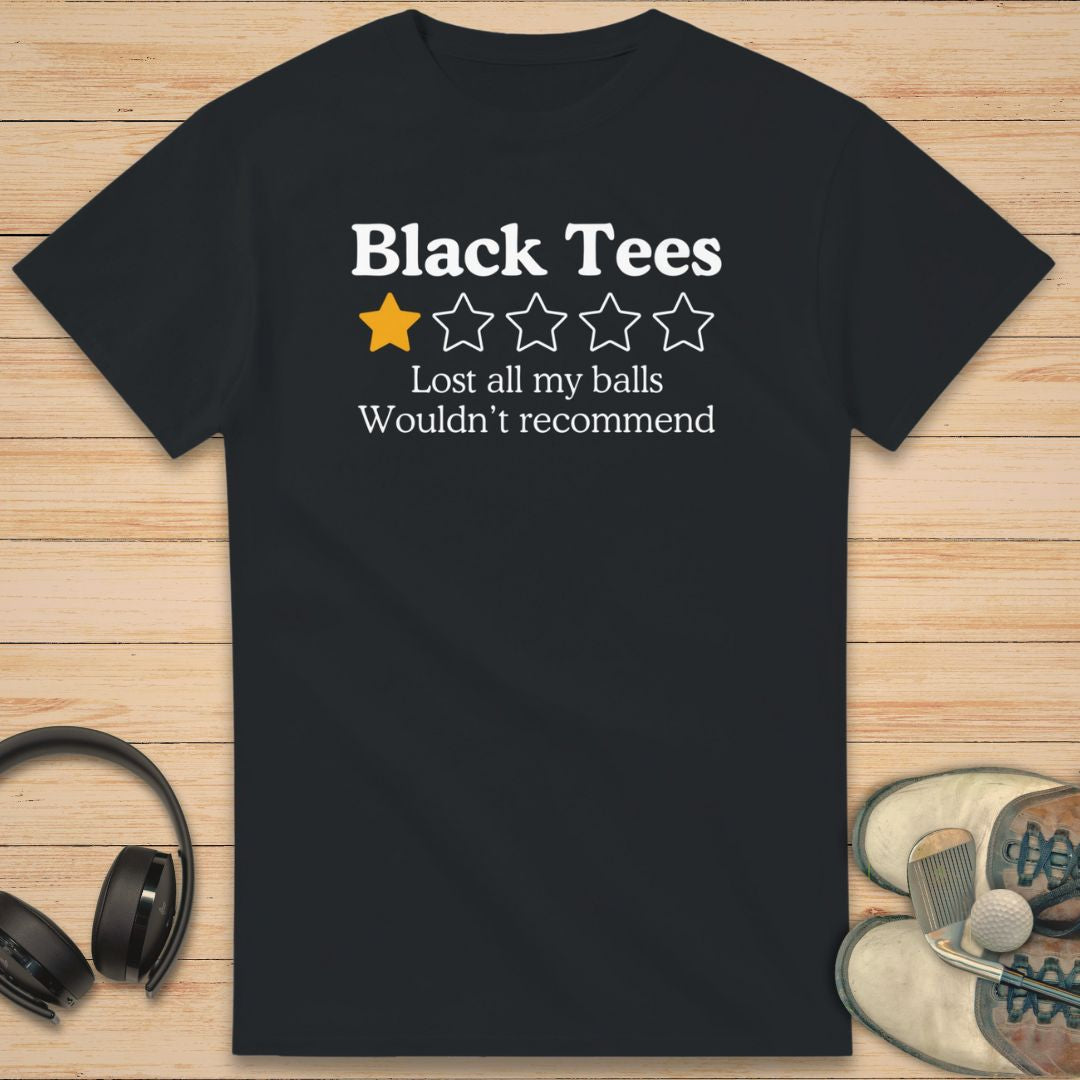 Black Tees T-Shirt in Black on a light wooden floor lying next to headphones and golf shoes.