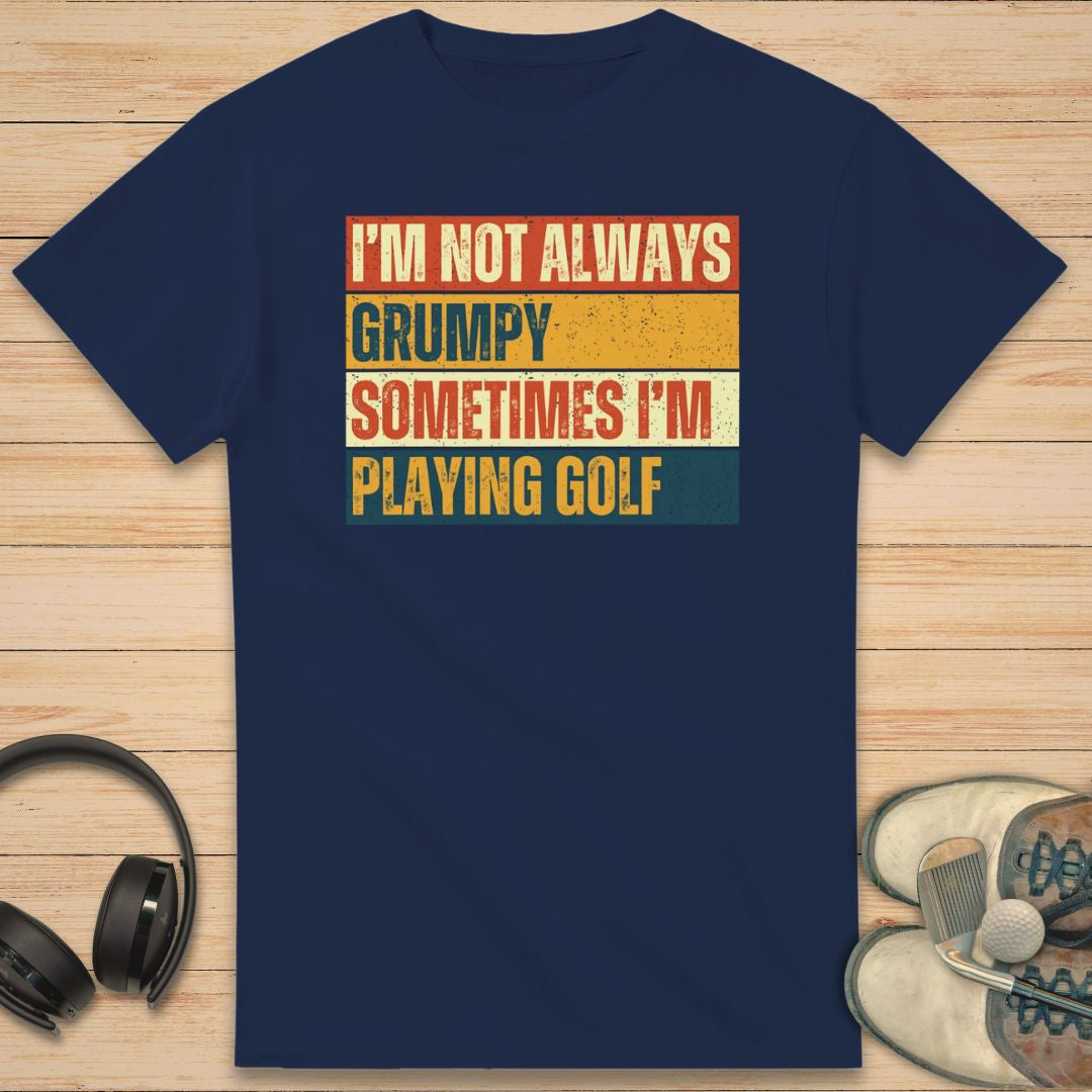 Grumpy Vintage T-Shirt in Navy on a light wooden floor lying next to headphones and golf shoes.