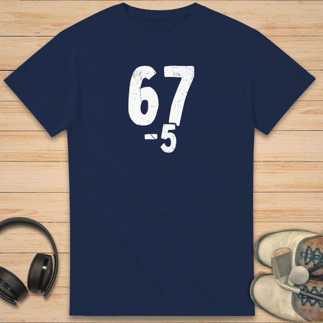 67 5 Under T-Shirt in Navy on a light wooden floor lying next to headphones and golf shoes.