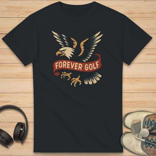 Forever Golf T-Shirt in on a light wooden floor lying next to headphones and golf shoes.