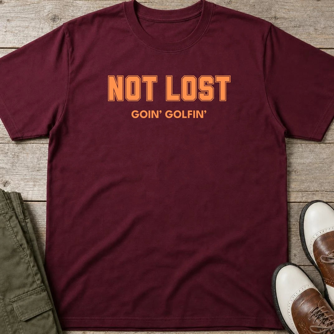 Not Lost T-Shirt in Maroon lying on a plain floor. T-shirt is a unisex cut and 100 per cent cotton.