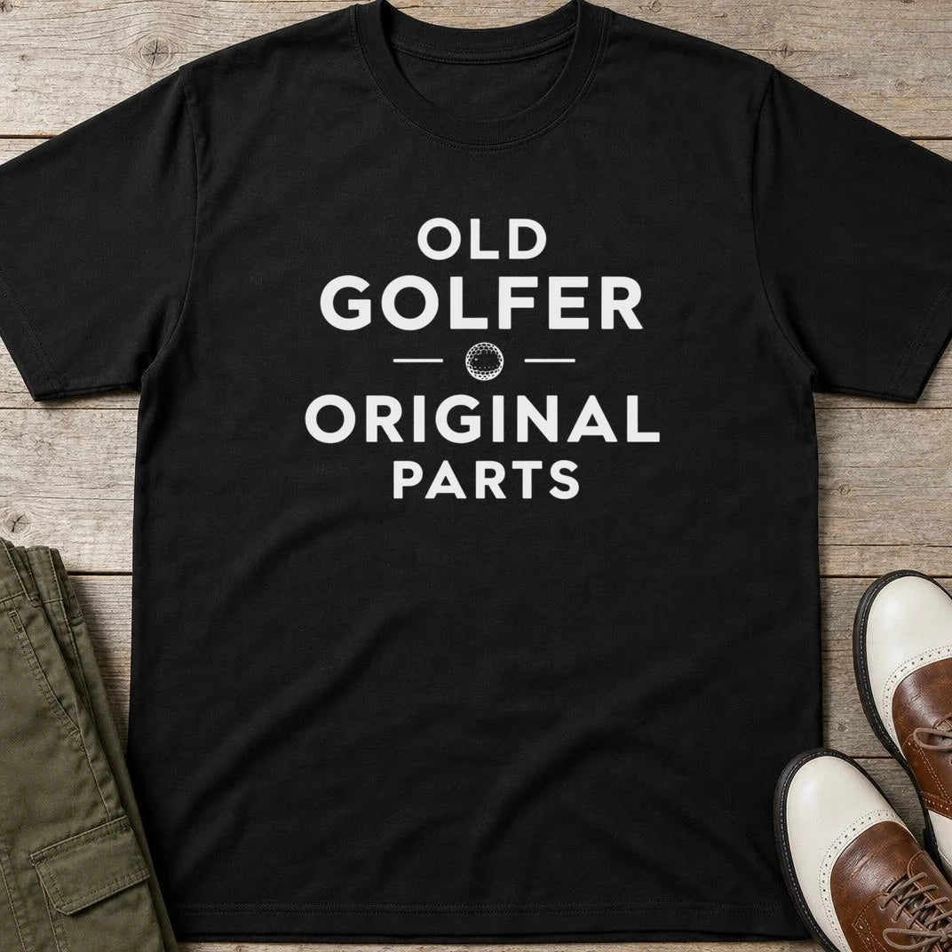 Old Golfer T-Shirt in Black lying on a plain floor. T-shirt is a unisex cut and 100 per cent cotton.