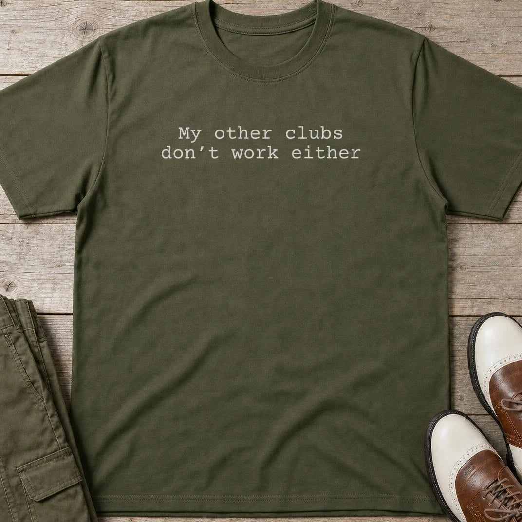 My Other Clubs T-Shirt in Military Green lying on a plain floor. T-shirt is a unisex cut and 100 per cent cotton.