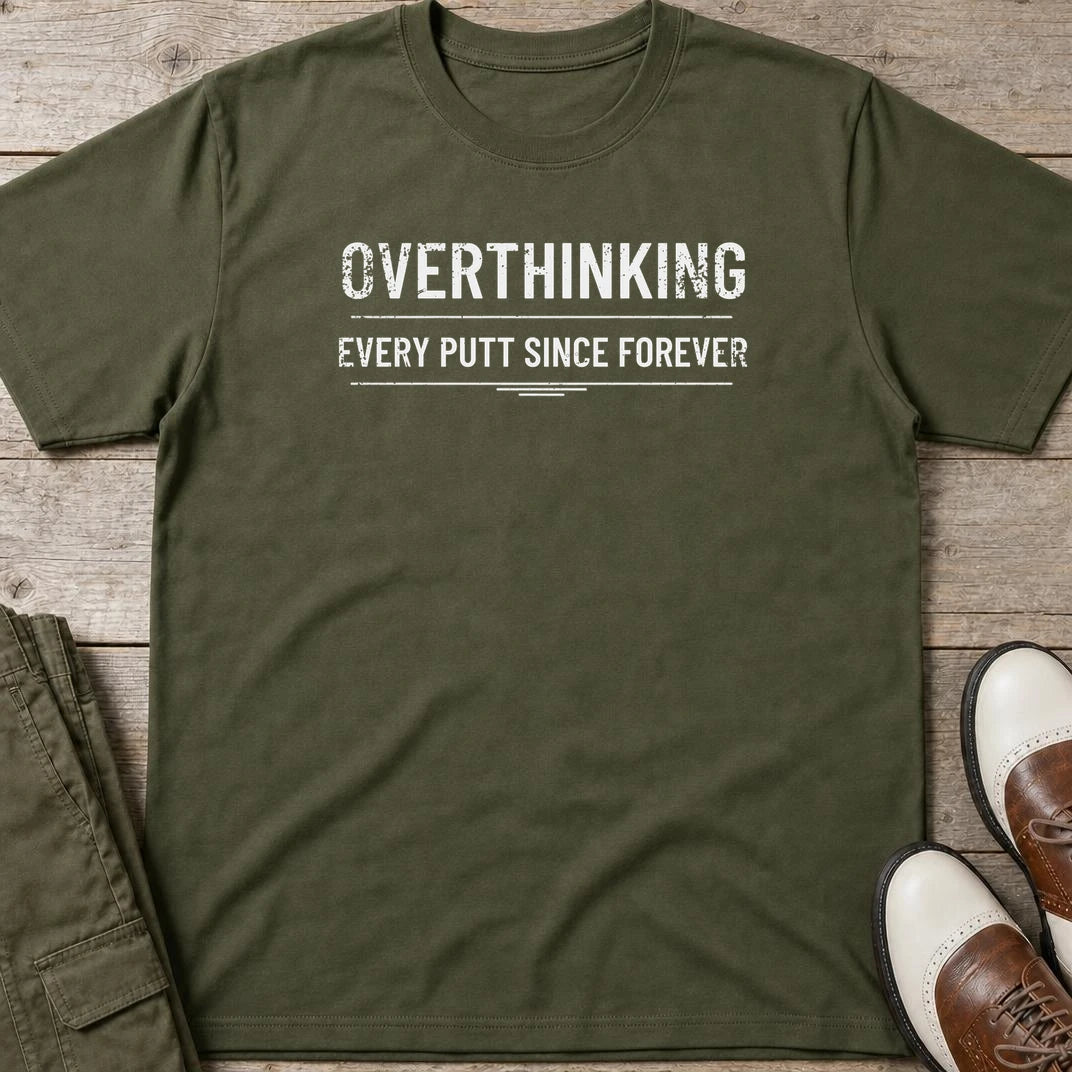 Every Putt T-Shirt in Military Green lying on a plain floor. T-shirt is a unisex cut and 100 per cent cotton.