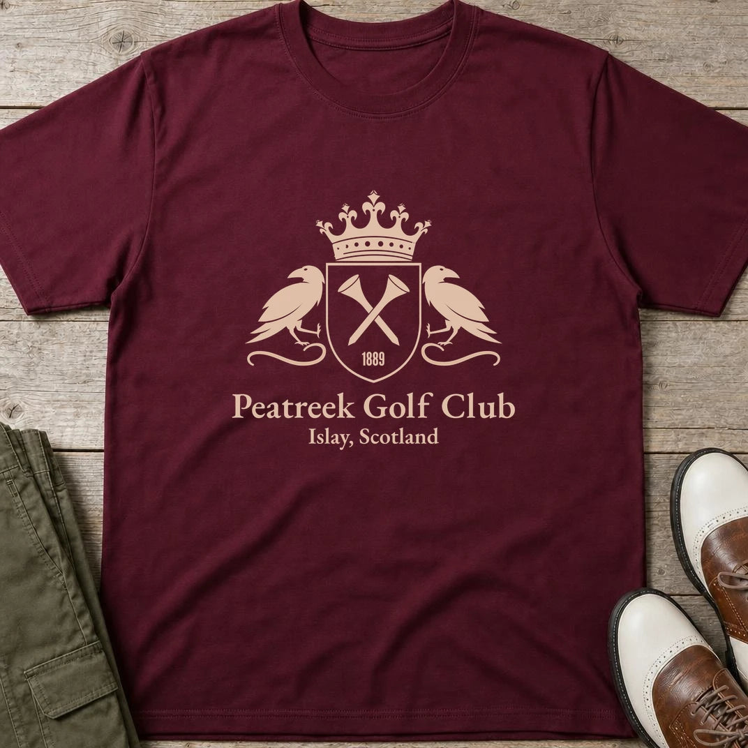 Peatreek GC T-Shirt in Maroon lying on a plain floor. T-shirt is a unisex cut and 100 per cent cotton.