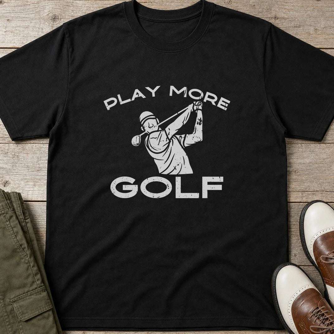 Play More Golf T-Shirt in Black lying on a plain floor. T-shirt is a unisex cut and 100 per cent cotton.