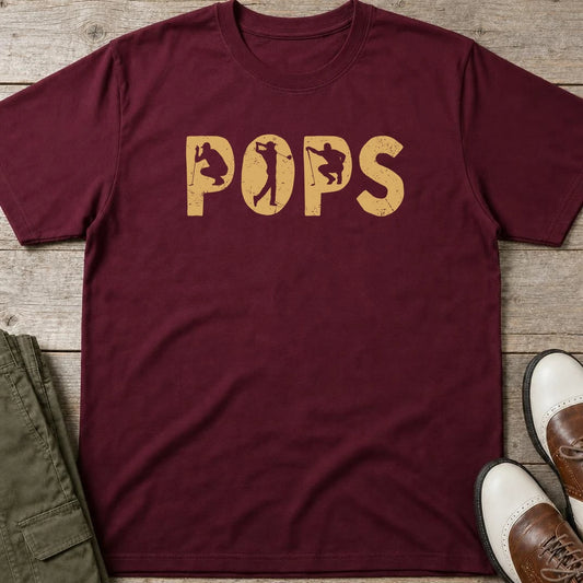 Pops Golf T-Shirt in Maroon lying on a plain floor. T-shirt is a unisex cut and 100 per cent cotton.