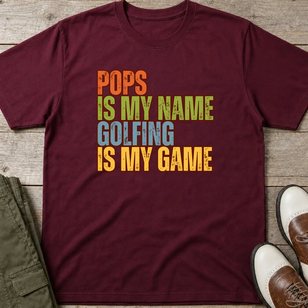 Pops My Name T-Shirt in Maroon lying on a plain floor. T-shirt is a unisex cut and 100 per cent cotton.