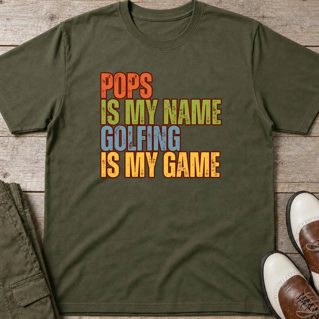 Pops My Name T-Shirt in Military Green lying on a plain floor. T-shirt is a unisex cut and 100 per cent cotton.