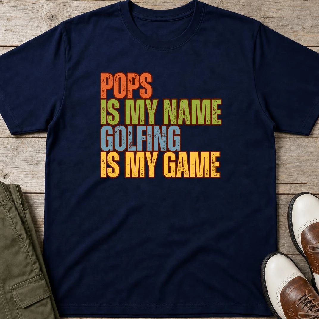 Pops My Name T-Shirt in Navy lying on a plain floor. T-shirt is a unisex cut and 100 per cent cotton.