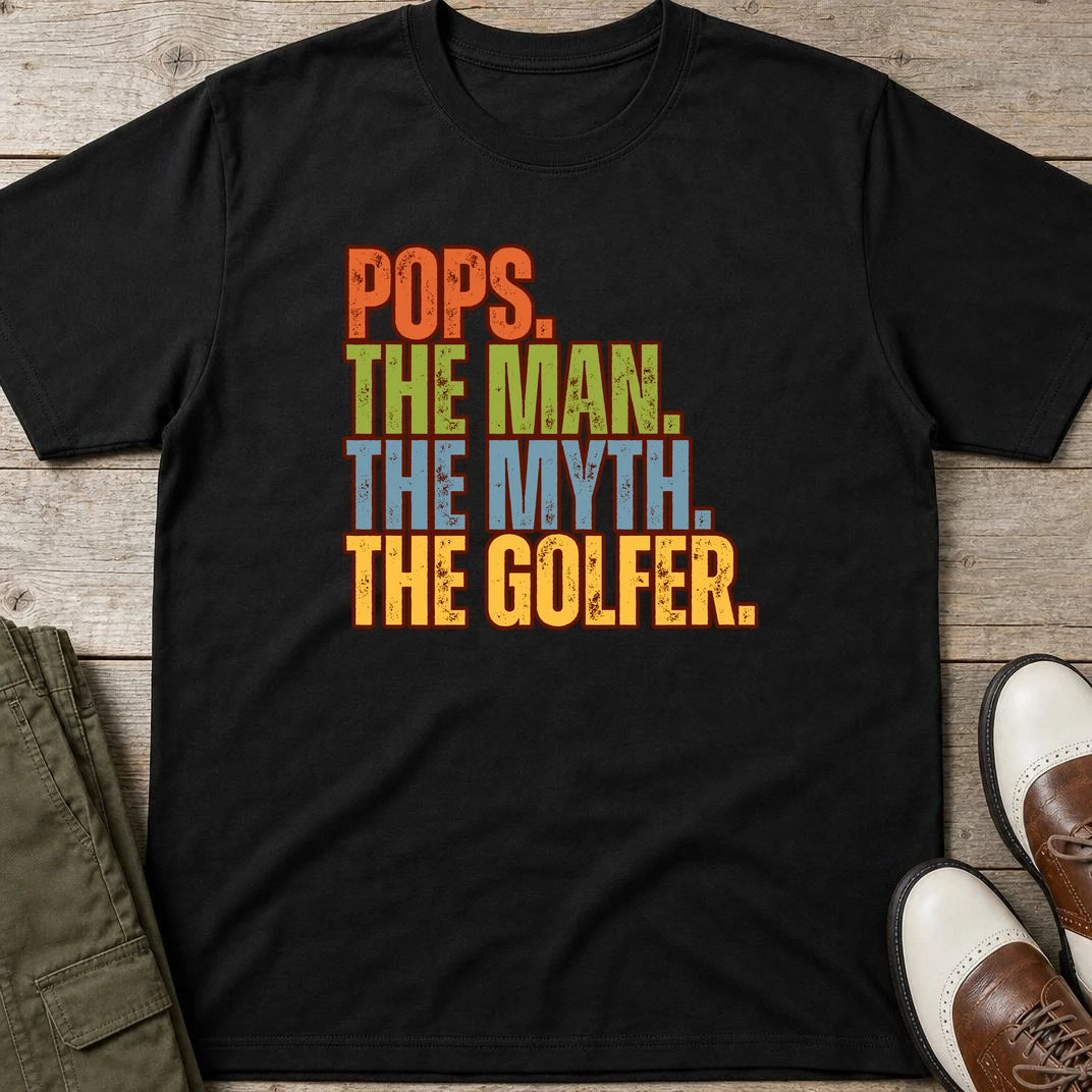 Pops Myth Golfer T-Shirt in Black lying on a plain floor. T-shirt is a unisex cut and 100 per cent cotton.