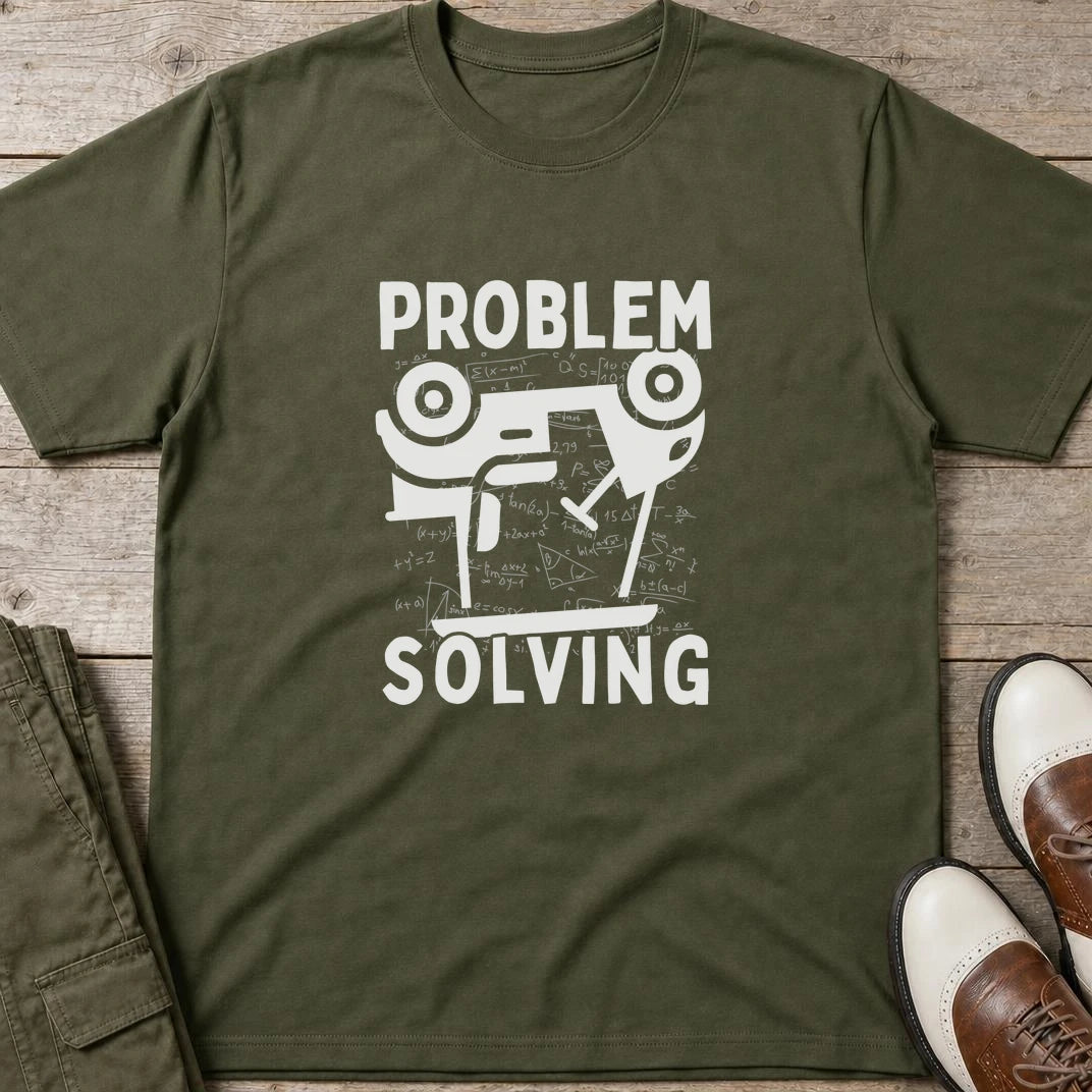 Problem Cart T-Shirt in Military Green lying on a plain floor. T-shirt is a unisex cut and 100 per cent cotton.