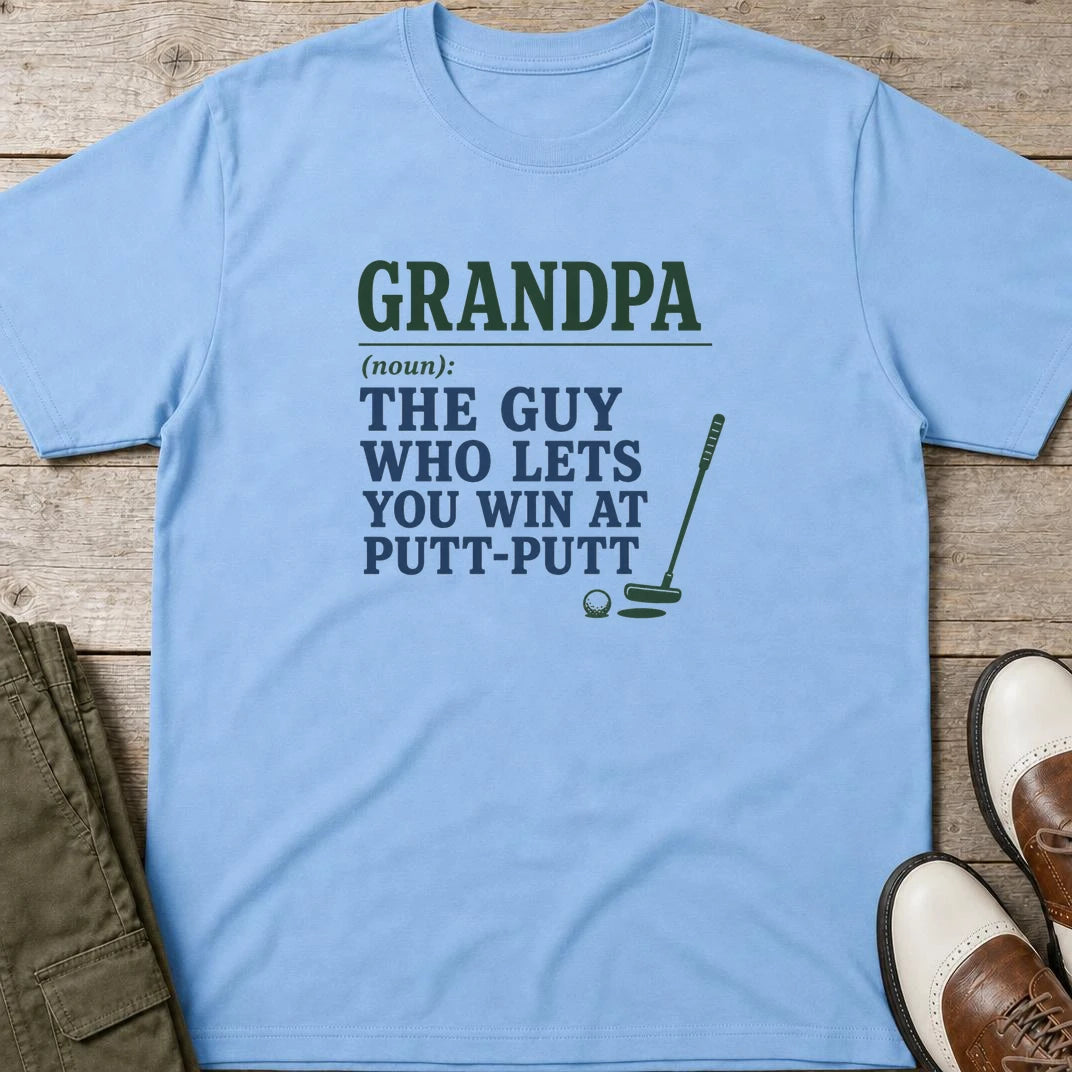 Putt-Putt T-Shirt in Light Blue lying on a plain floor. T-shirt is a unisex cut and 100 per cent cotton.