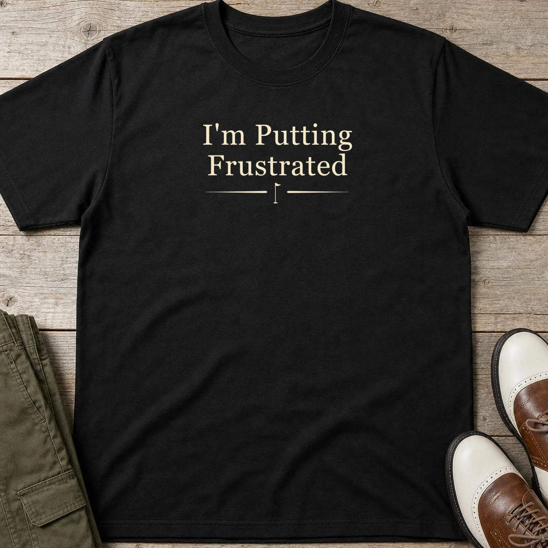 Putting Frustrated T-Shirt in Black lying on a plain floor. T-shirt is a unisex cut and 100 per cent cotton.