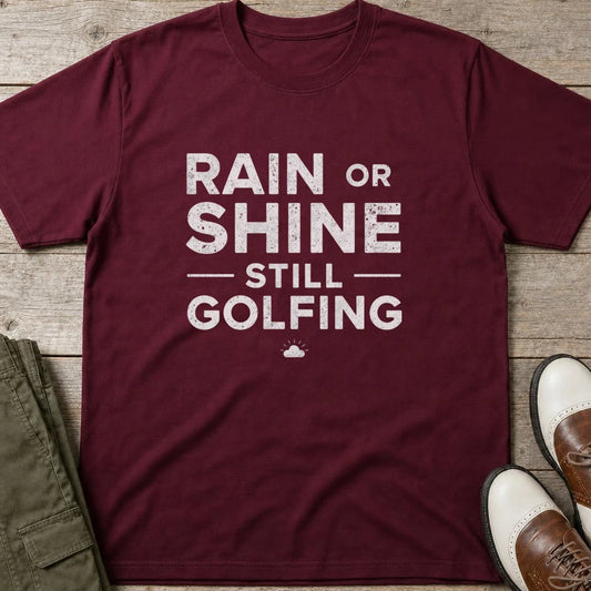 Rain Or Shine T-Shirt in Maroon lying on a plain floor. T-shirt is a unisex cut and 100 per cent cotton.
