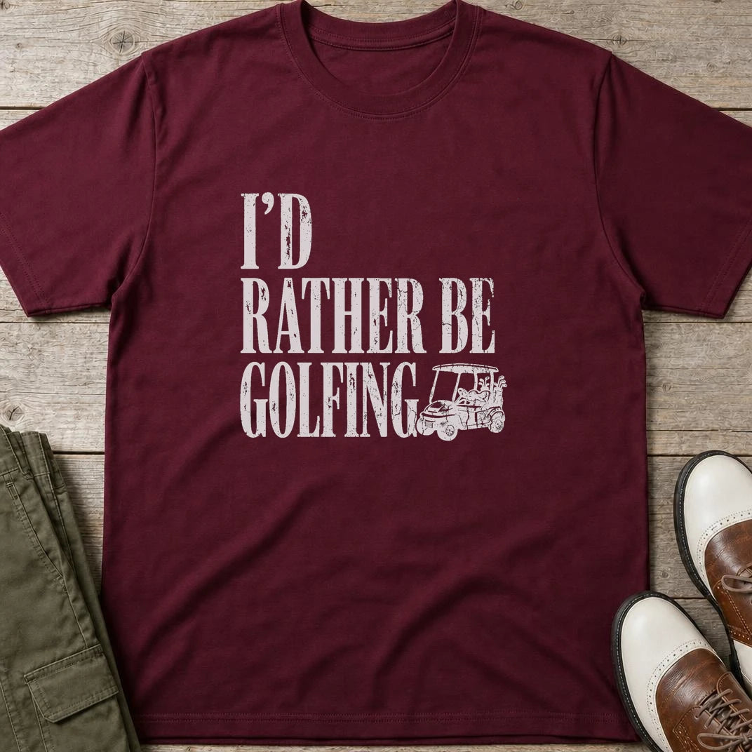 Rather Be Golfing II T-Shirt in Maroon lying on a plain floor. T-shirt is a unisex cut and 100 per cent cotton.