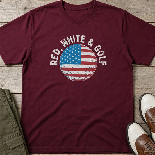 Red White & Golf T-Shirt in Maroon lying on a plain floor. T-shirt is a unisex cut and 100 per cent cotton.