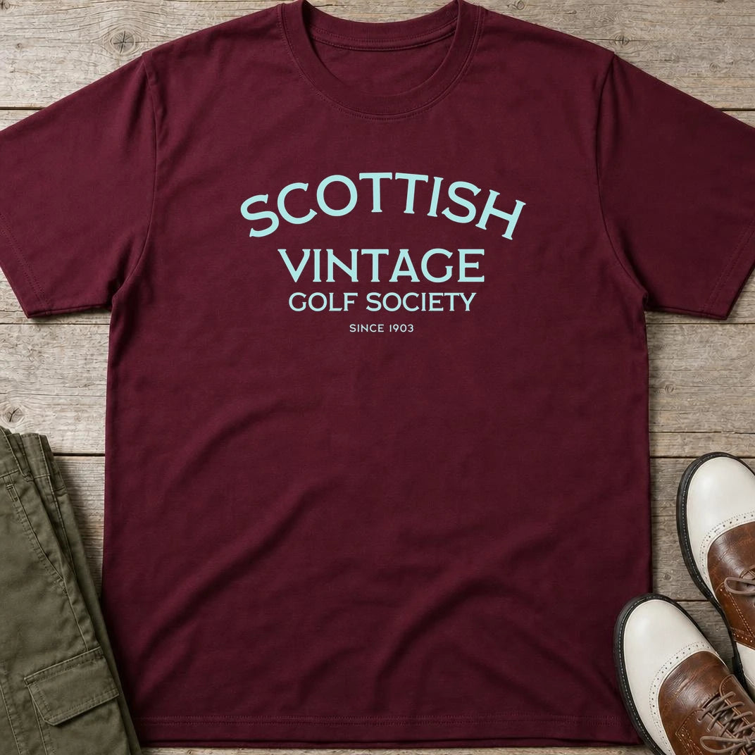 Scottish 1903 T-Shirt in Maroon lying on a plain floor. T-shirt is a unisex cut and 100 per cent cotton.