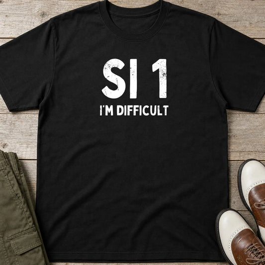 SI 1 T-Shirt in Black lying on a plain floor. T-shirt is a unisex cut and 100 per cent cotton.