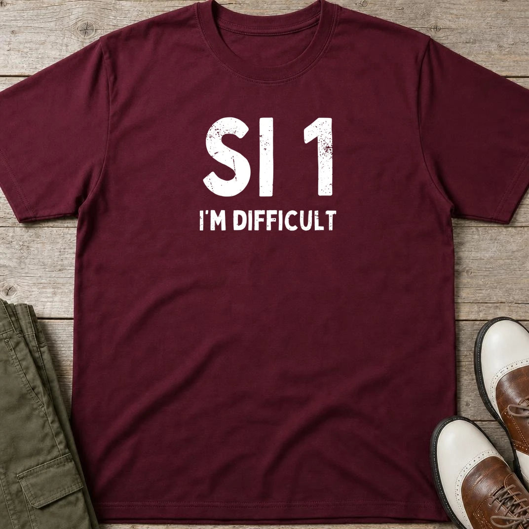 SI 1 T-Shirt in Maroon lying on a plain floor. T-shirt is a unisex cut and 100 per cent cotton.