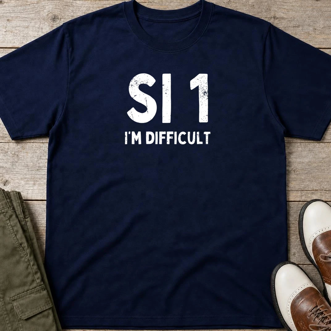 SI 1 T-Shirt in Navy lying on a plain floor. T-shirt is a unisex cut and 100 per cent cotton.