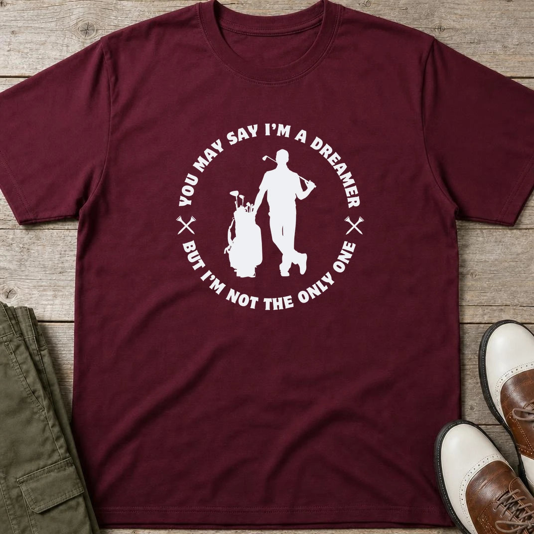 You May Say I'm A Dreamer T-Shirt in Maroon lying on a plain floor. T-shirt is a unisex cut and 100 per cent cotton.