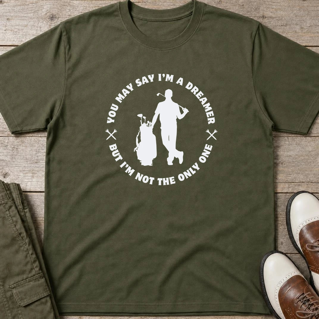 You May Say I'm A Dreamer T-Shirt in Military Green lying on a plain floor. T-shirt is a unisex cut and 100 per cent cotton.