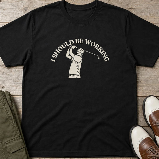 Should Be T-Shirt in Black lying on a plain floor. T-shirt is a unisex cut and 100 per cent cotton.