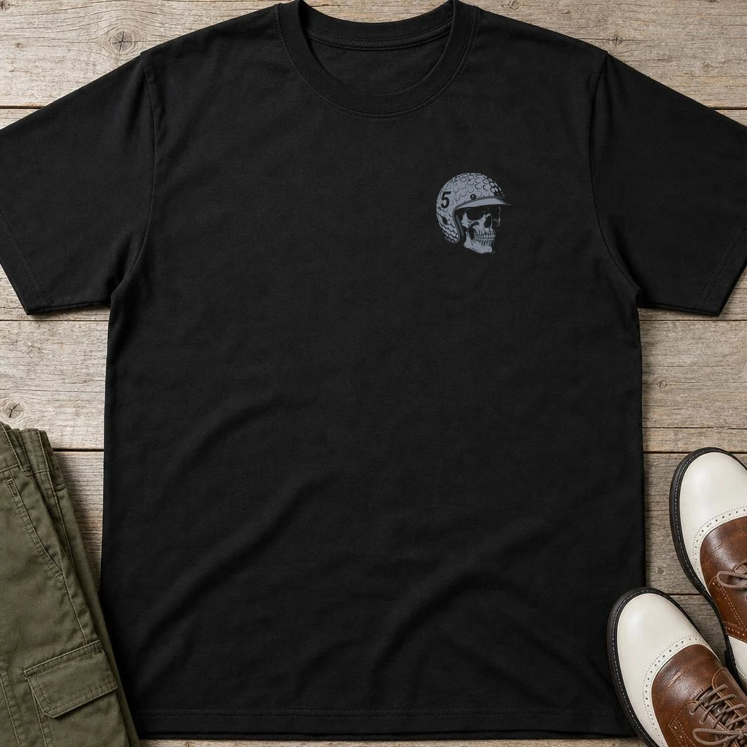 Skull Golfer Pocket T-Shirt in Black lying on a plain floor. T-shirt is a unisex cut and 100 per cent cotton.