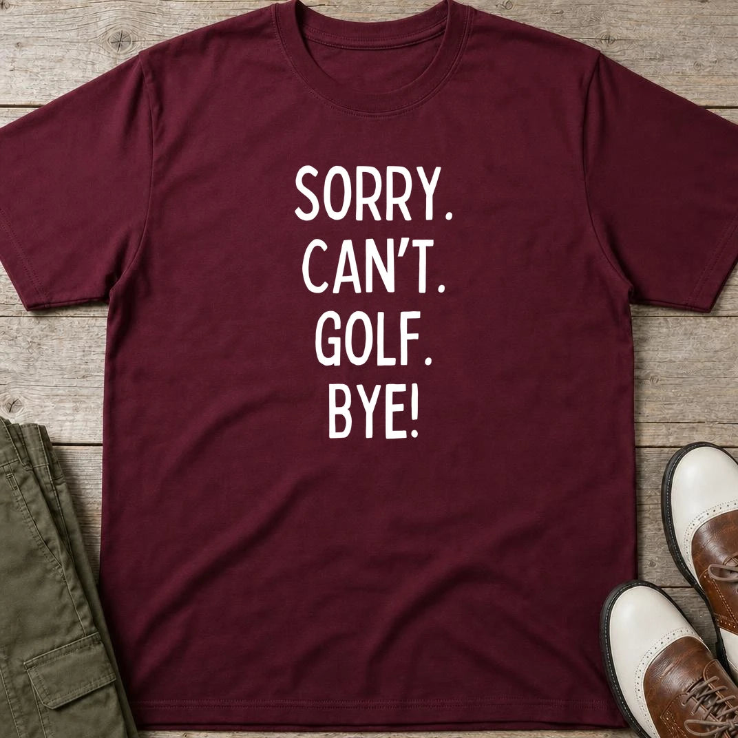 Sorry. Golf T-Shirt in Maroon lying on a plain floor. T-shirt is a unisex cut and 100 per cent cotton.