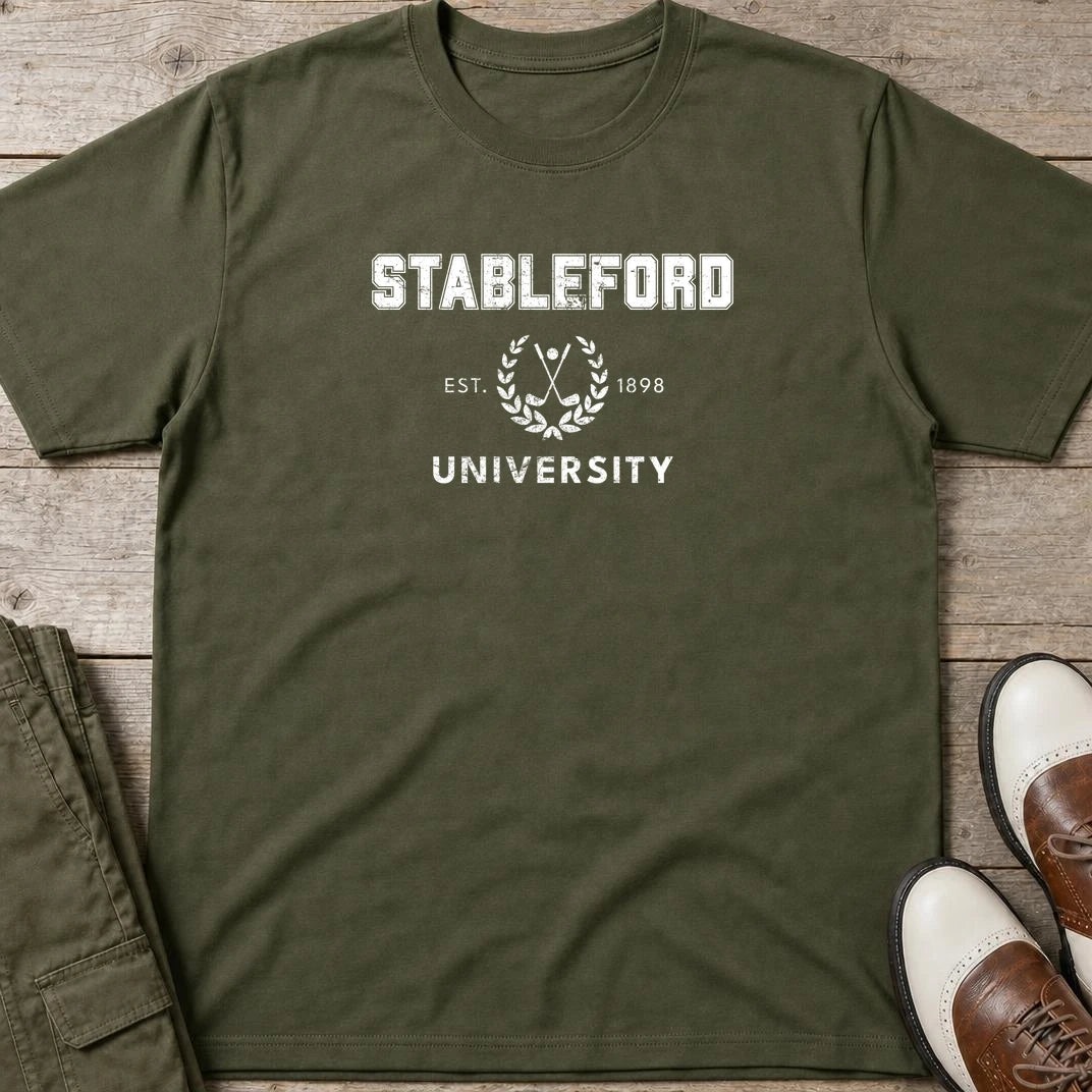Stableford University T-Shirt in Military Green lying on a plain floor. T-shirt is a unisex cut and 100 per cent cotton.