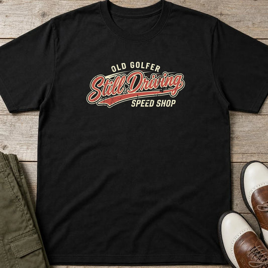 Still Driving T-Shirt in lying on a plain floor. T-shirt is a unisex cut and 100 per cent cotton.