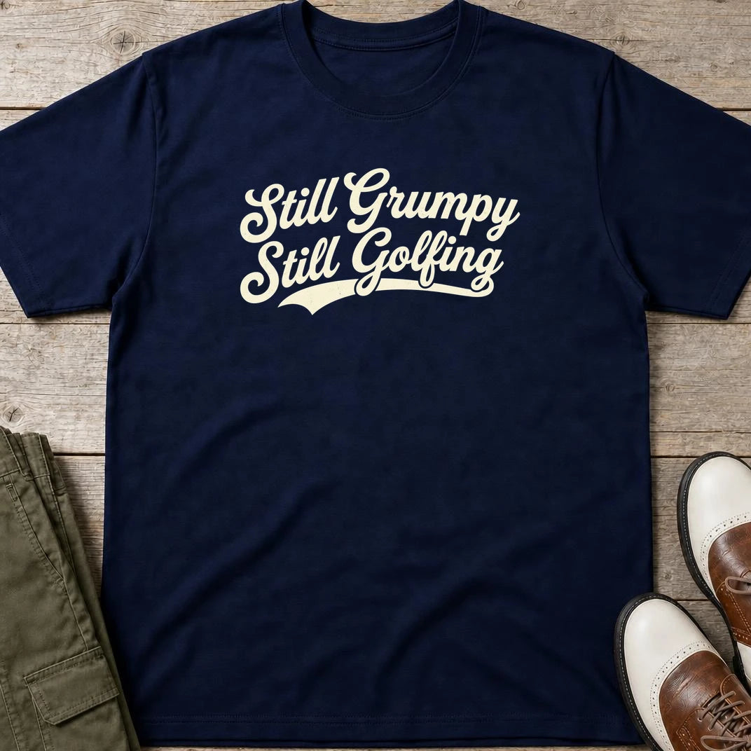 Still Grumpy T-Shirt in Navy lying on a plain floor. T-shirt is a unisex cut and 100 per cent cotton.
