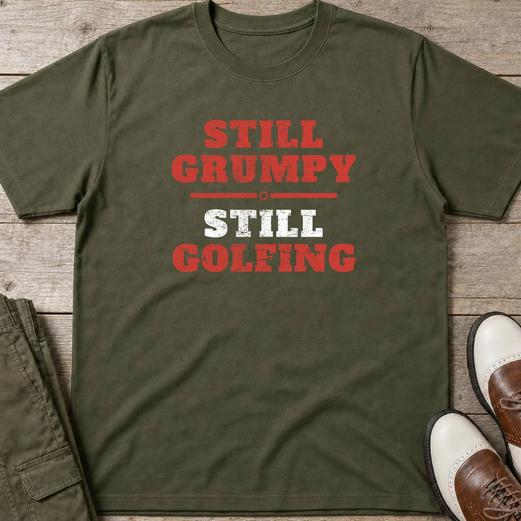 Still Grumpy Red T-Shirt in Military Green lying on a plain floor. T-shirt is a unisex cut and 100 per cent cotton.