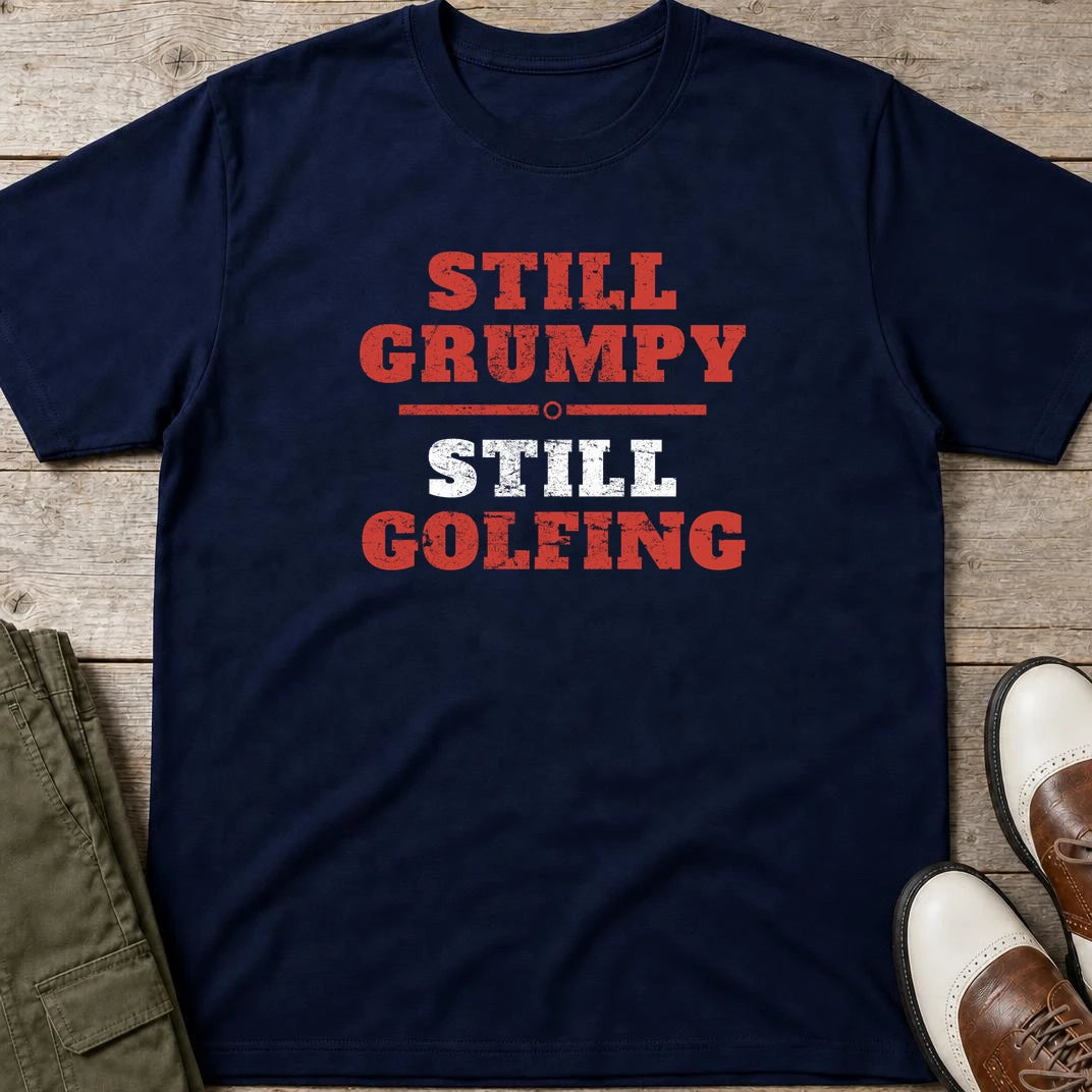 Still Grumpy Red T-Shirt in Navy lying on a plain floor. T-shirt is a unisex cut and 100 per cent cotton.