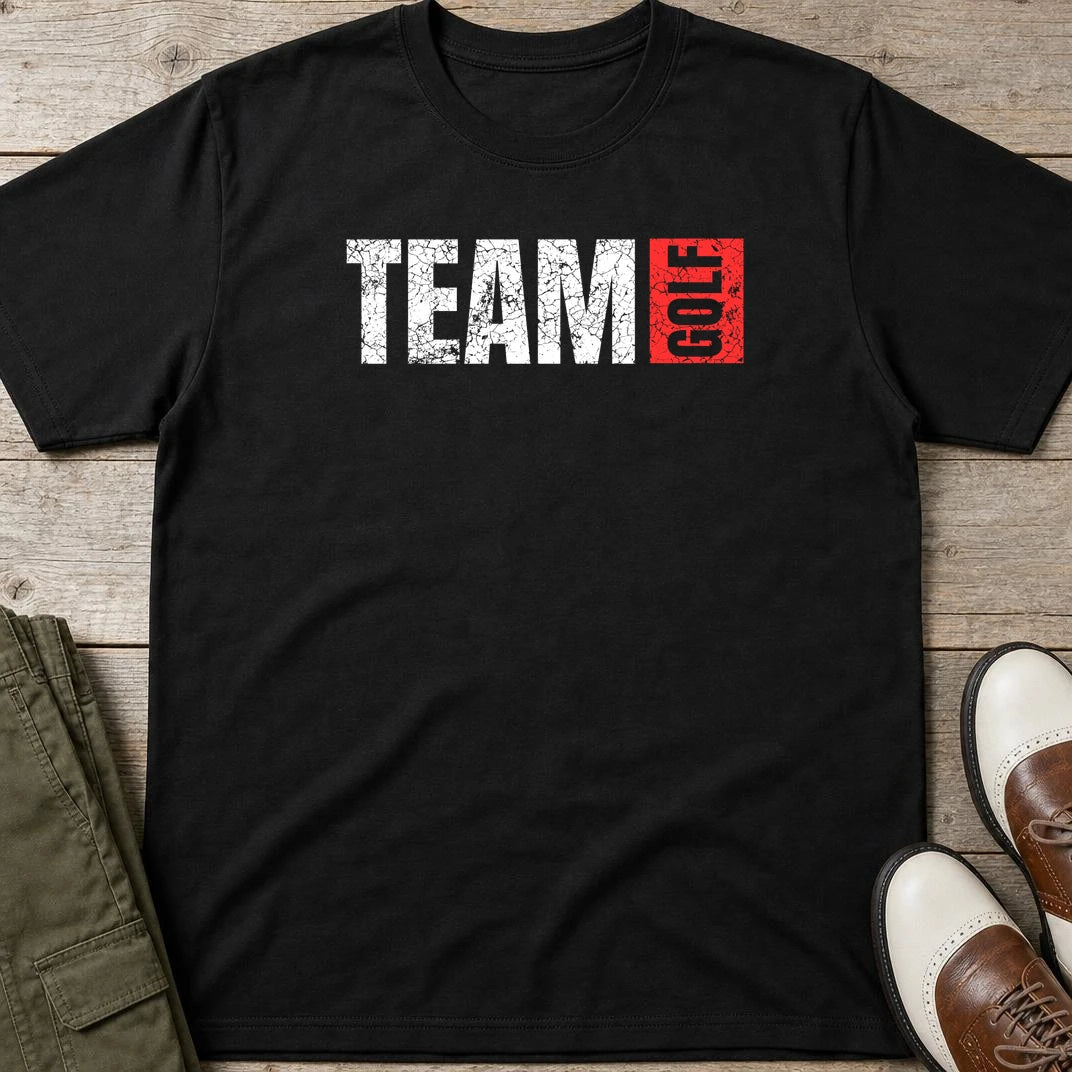 Team Golf T-Shirt in Black lying on a plain floor. T-shirt is a unisex cut and 100 per cent cotton.