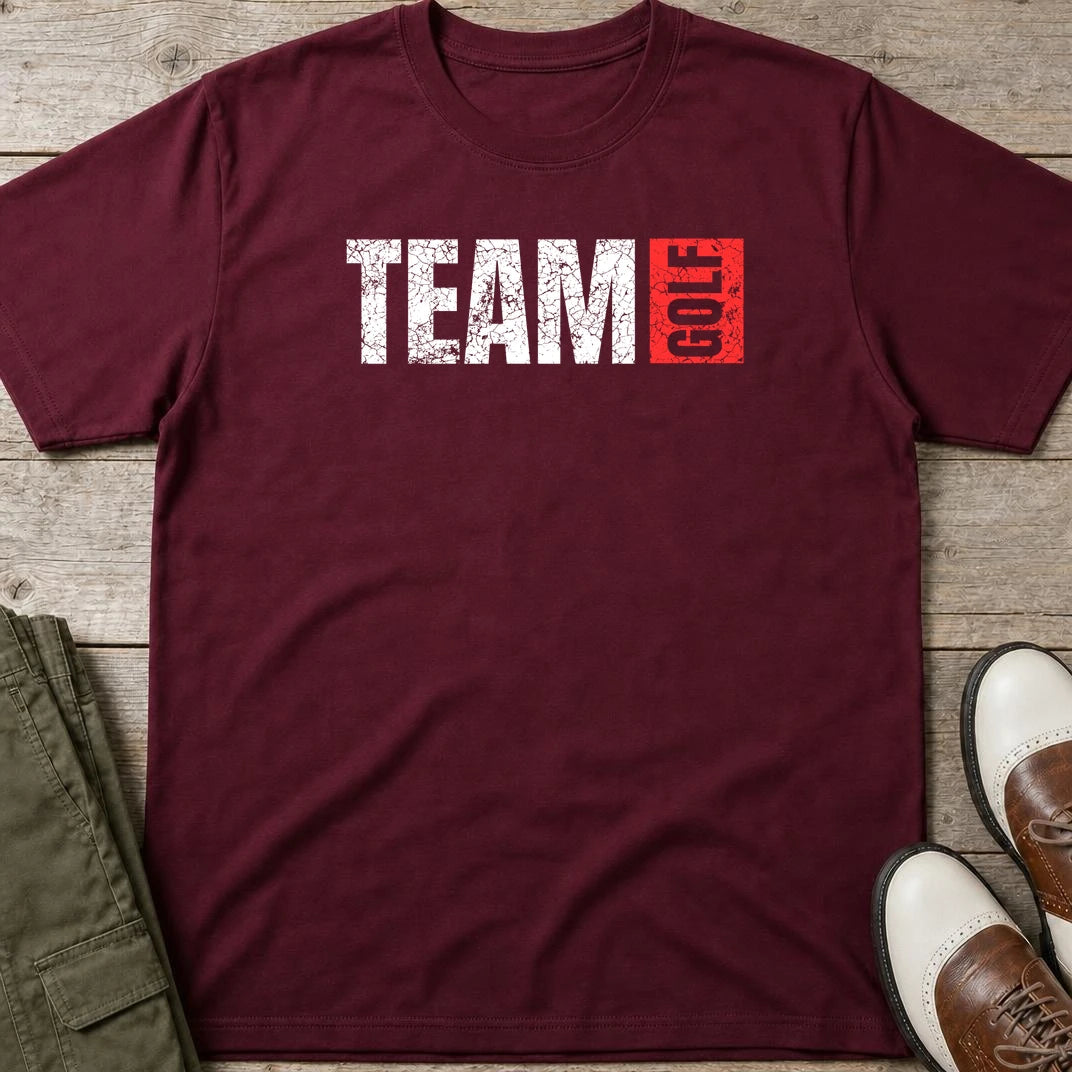 Team Golf T-Shirt in Maroon lying on a plain floor. T-shirt is a unisex cut and 100 per cent cotton.