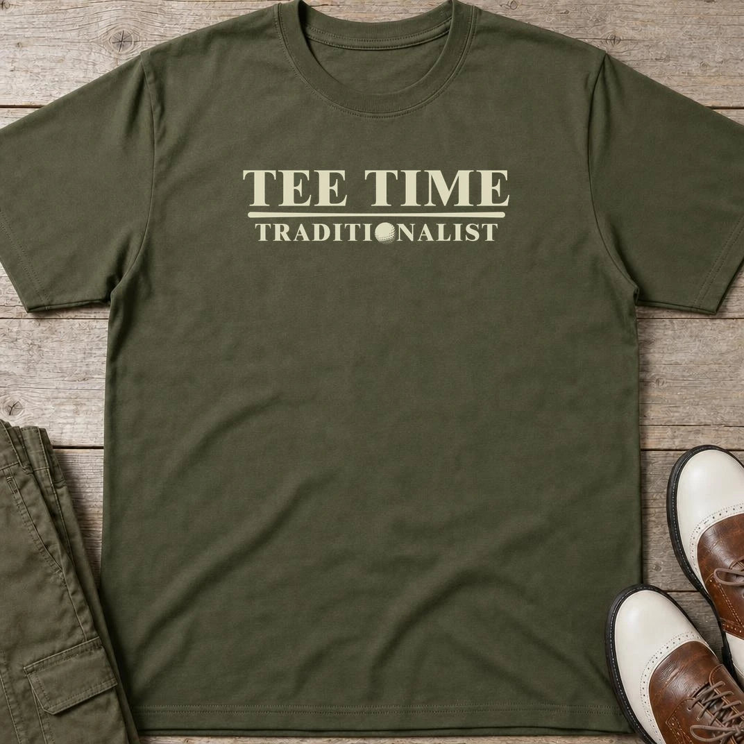 Traditionalist T-Shirt in Military Green lying on a plain floor. T-shirt is a unisex cut and 100 per cent cotton.