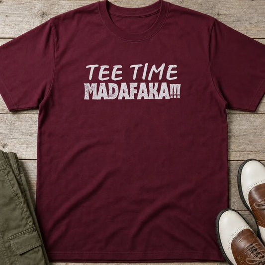 Tee Time T-Shirt in Maroon lying on a plain floor. T-shirt is a unisex cut and 100 per cent cotton.