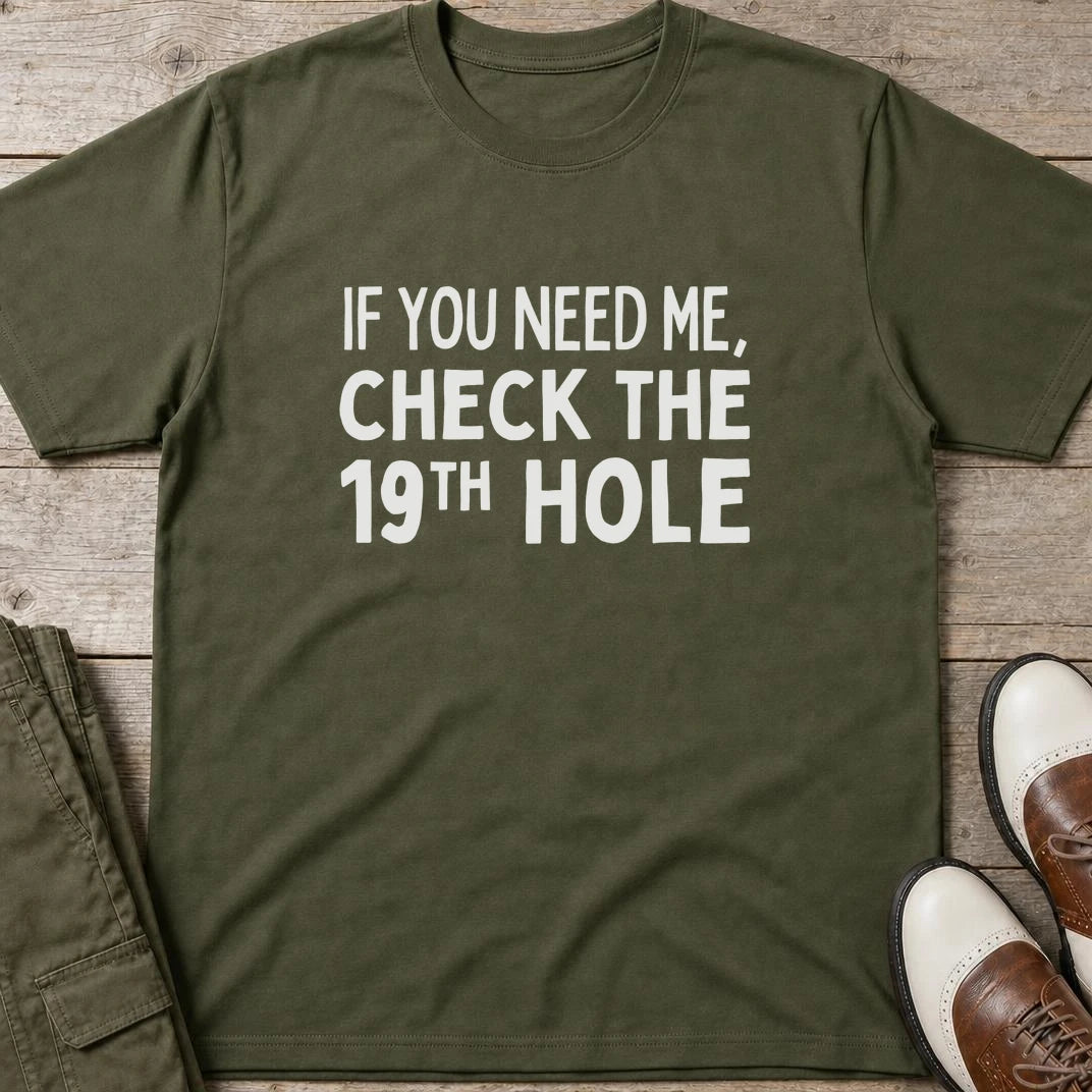Check The 19th T-Shirt in Military Green lying on a plain floor. T-shirt is a unisex cut and 100 per cent cotton.