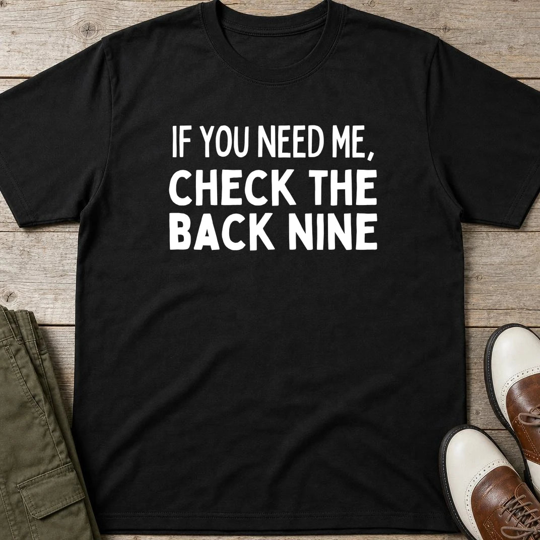 The Back Nine T-Shirt in Black lying on a plain floor. T-shirt is a unisex cut and 100 per cent cotton.