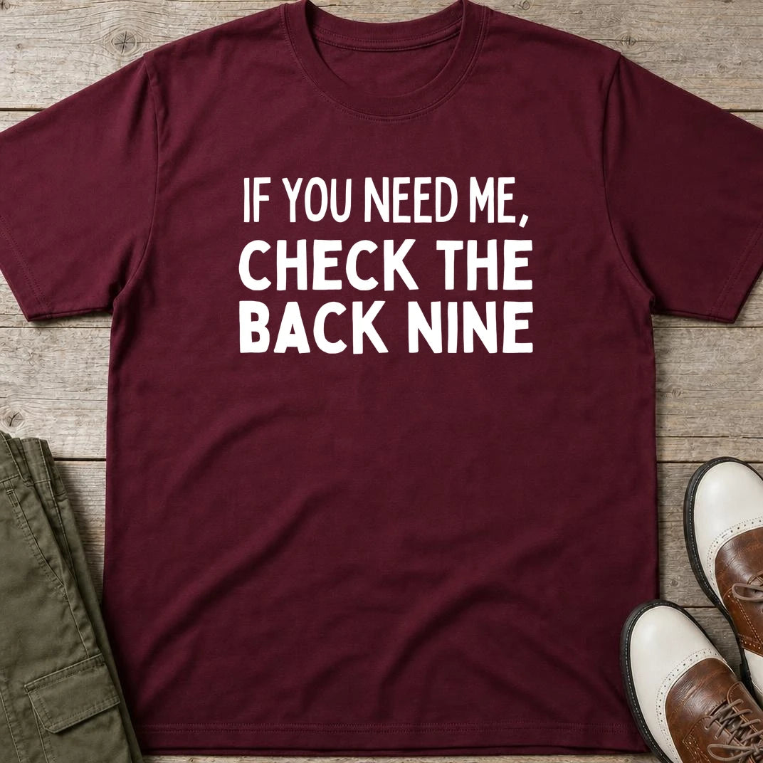 The Back Nine T-Shirt in Maroon lying on a plain floor. T-shirt is a unisex cut and 100 per cent cotton.