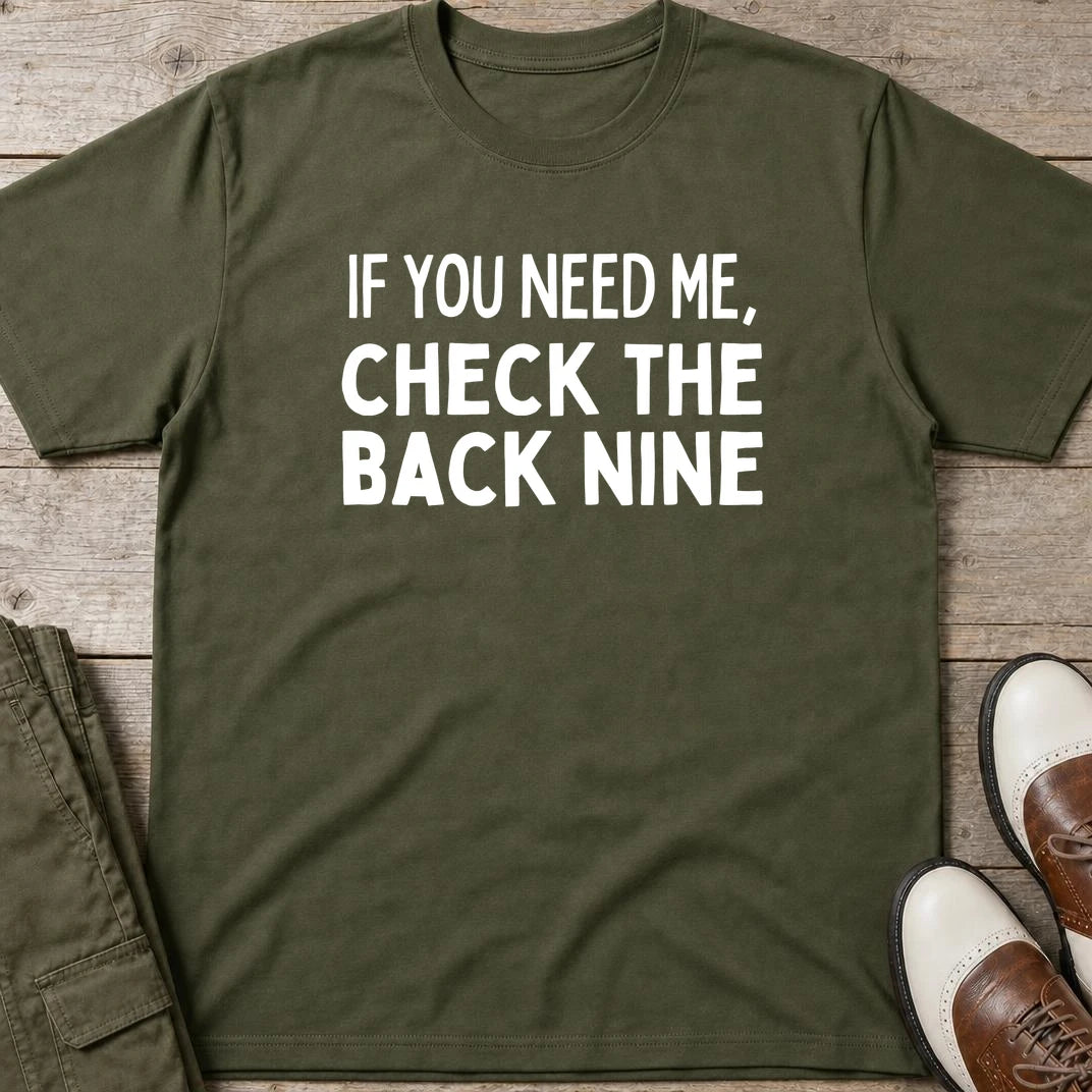 The Back Nine T-Shirt in Military Green lying on a plain floor. T-shirt is a unisex cut and 100 per cent cotton.