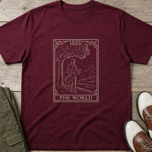 The World T-Shirt in Maroon lying on a plain floor. T-shirt is a unisex cut and 100 per cent cotton.