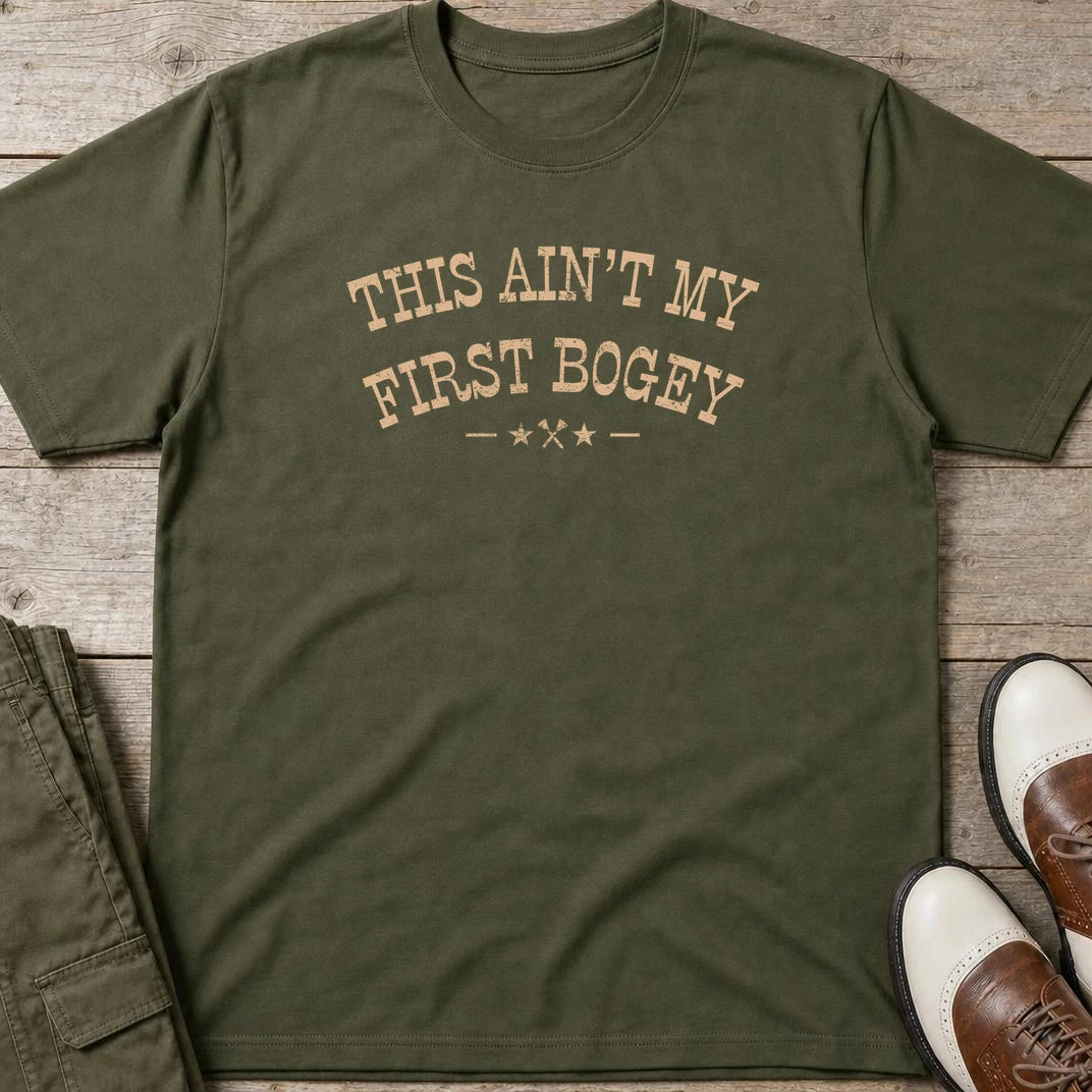First Bogey T-Shirt in Military Green lying on a plain floor. T-shirt is a unisex cut and 100 per cent cotton.