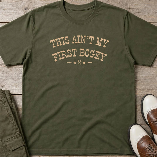 First Bogey T-Shirt in Military Green lying on a plain floor. T-shirt is a unisex cut and 100 per cent cotton.
