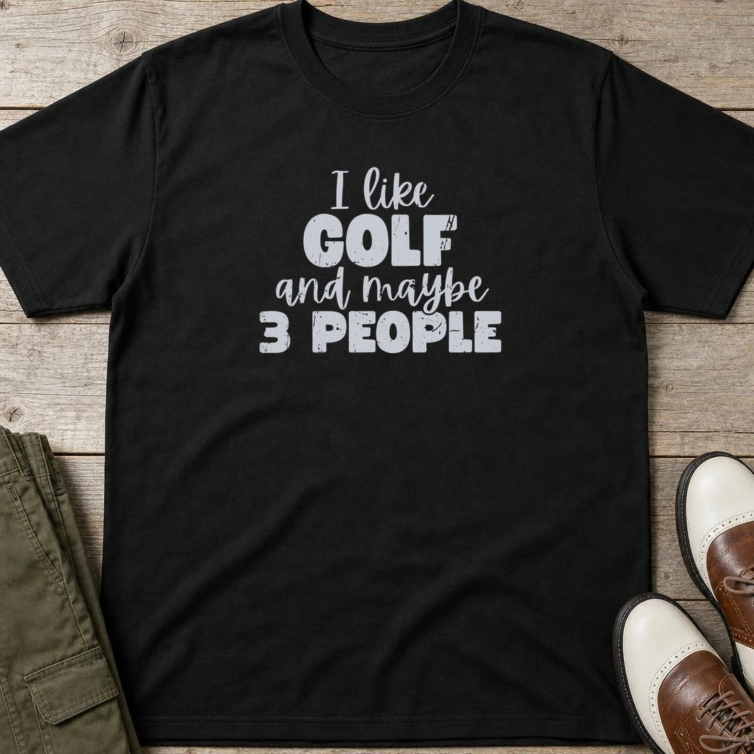 I Like Golf T-Shirt in Black lying on a plain floor. T-shirt is a unisex cut and 100 per cent cotton.